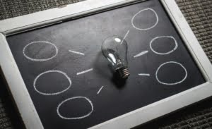 A lightbulb on a chalkboard with circles drawn on it represents shining a light on substance use disorders