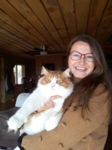 Libby McCaskey, SUDP, smiling and holding a large cat