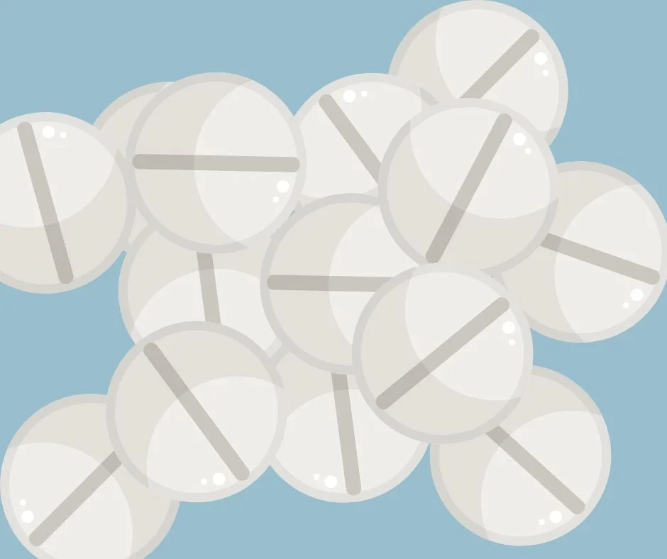 Round white pills that could contain fentanyl on a blue background