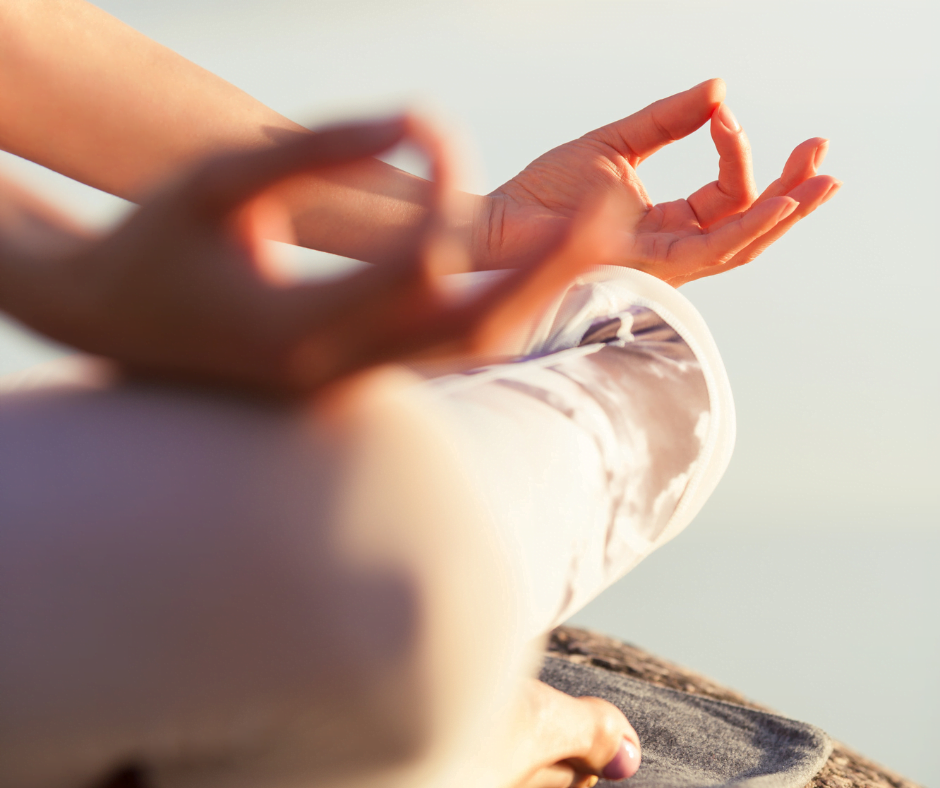 image of hands in Gyan Mudra meditation pose resting on knees